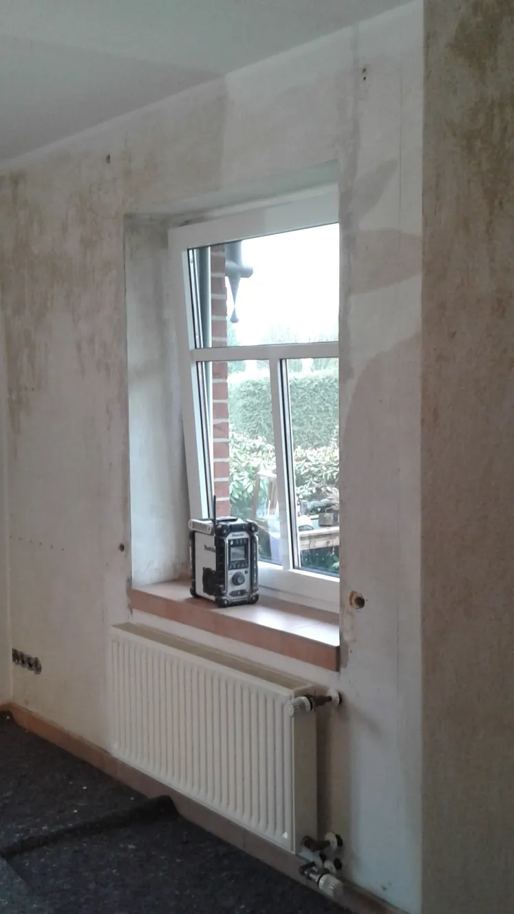 Vorher: Wand mit Flecken und alten Tapetenresten, Boden abgedeckt